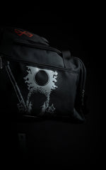 Side view of the Berserk travel bag showcasing the silver screen-printed graphic of Guts, the Eclipse, and the hilt of the Dragon Slayer sword.
