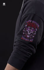 Side profile of a black Mavrick anime hoodie showcasing a detailed sleeve graphic of a stylized Eustass Kid skull with goggles and "Punk Rotten" typography in purple and red.