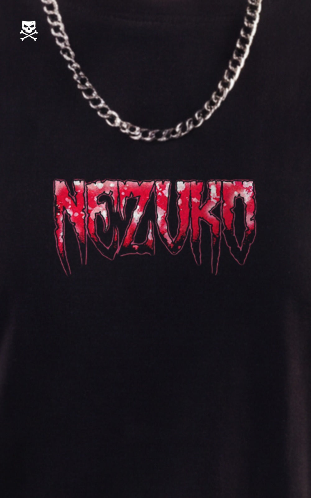 Close-up of the front of a black t-shirt featuring a "Nezuko" logo in a red and white dripping, heavy metal-style font, styled with a silver cuban link chain.