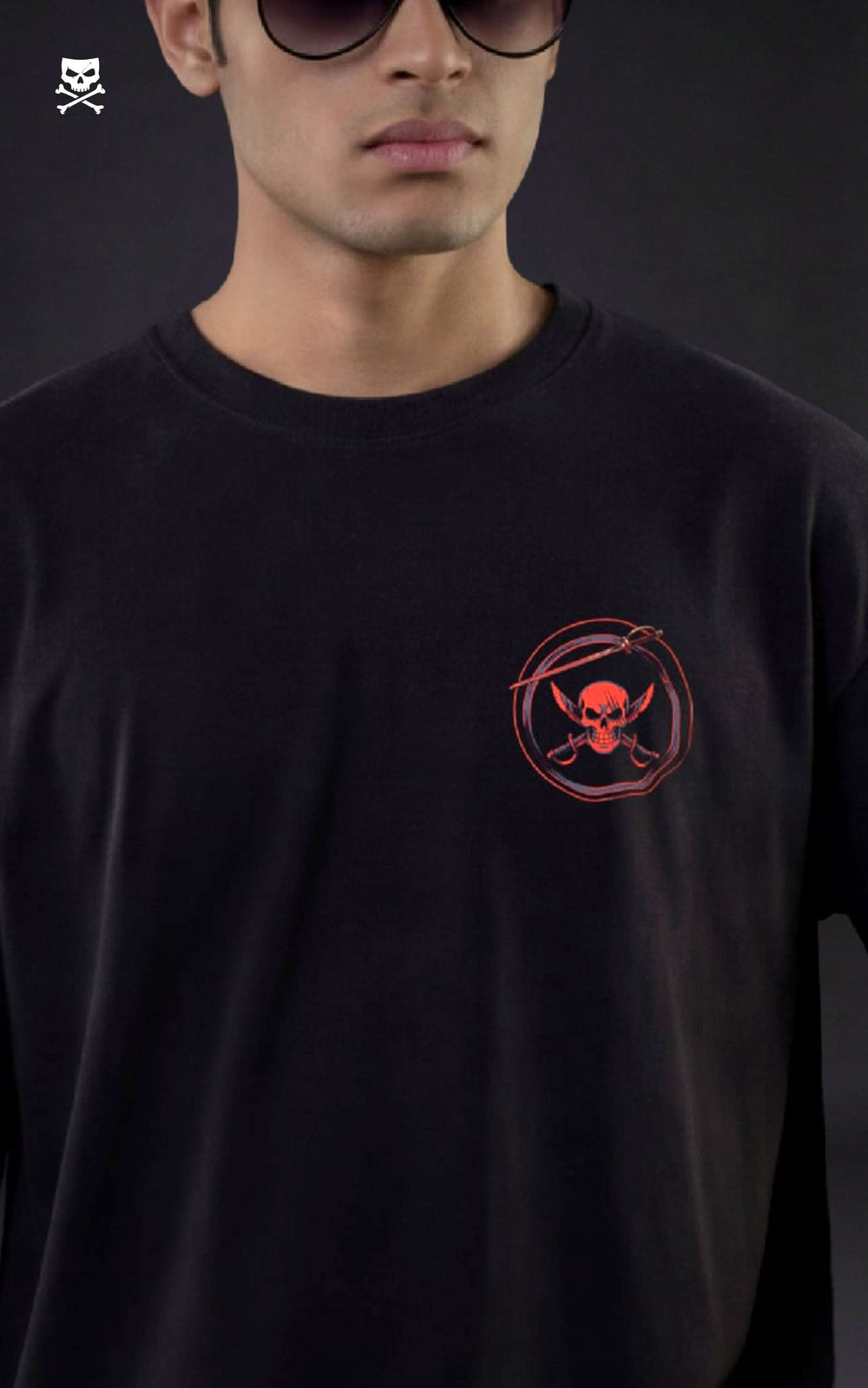 Person wearing a black t-shirt with a red logo on a dark background