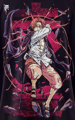 Closeup view of a male model wearing a boxy black oversized shirt featuring a crimson Haki graphic of Red-Haired Shanks with his sword drawn.