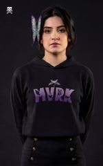 Front view of a woman wearing a Mavrick Shinobu Kocho black anime hoodie with purple "MVRK" gradient lettering and butterfly graphics, featuring a matching butterfly hair accessory.