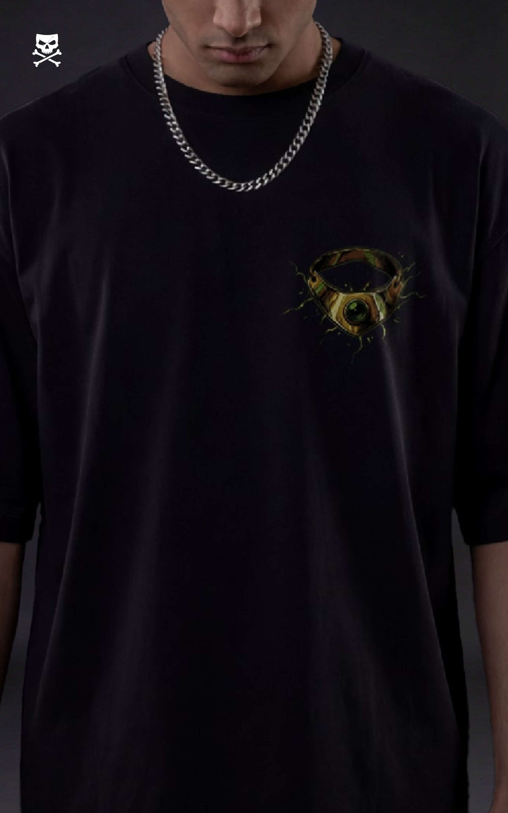 Person wearing a black t-shirt with a yellow broly ring on a black oversized t-shirt