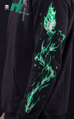Side profile of a black Bleach streetwear hoodie showing a glowing teal and silver Lanza del Relámpago energy spear graphic printed on the sleeve.