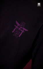 
Detailed close-up of a purple screen-printed chest logo on a black cotton t-shirt. The minimalist graphic combines a traditional Japanese torii gate with stylized kanji lettering for an urban fashion aesthetic.