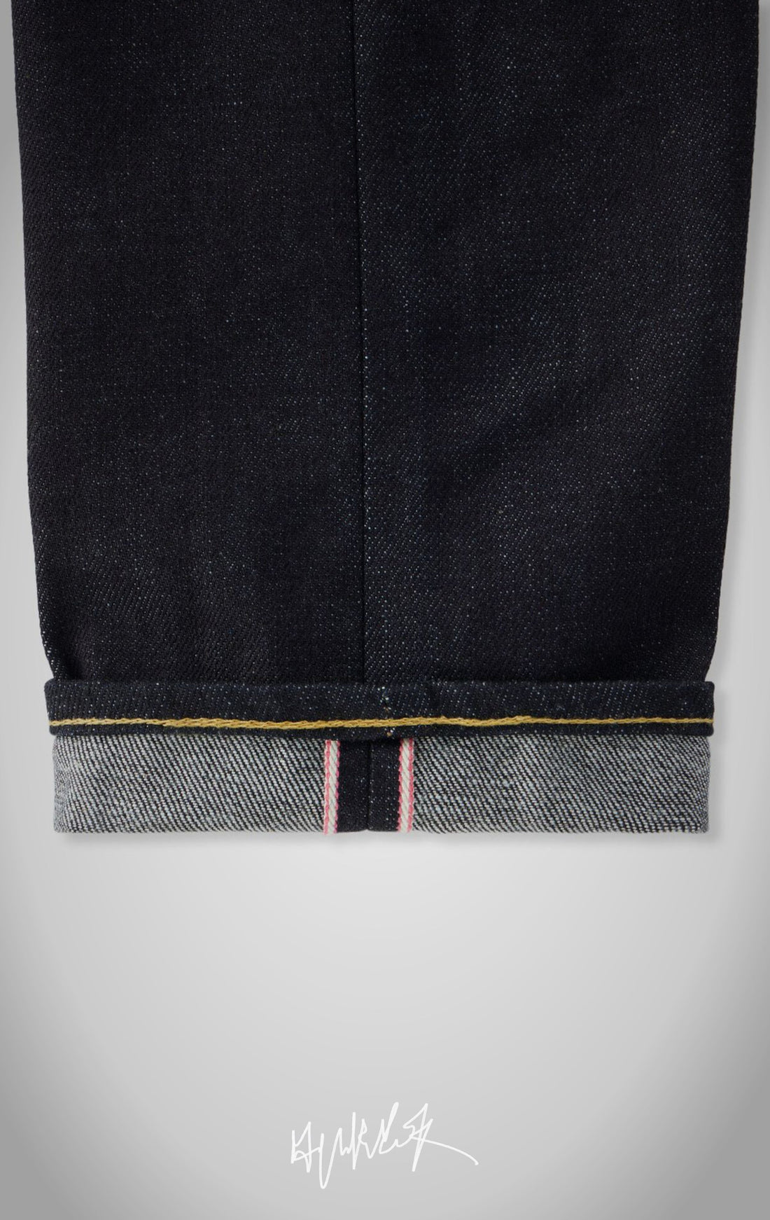 Model wearing IRON CUT dark indigo straight-leg selvedge jeans.