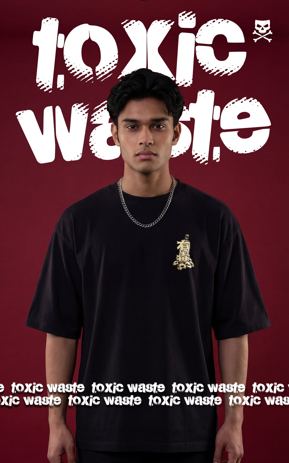 Front view of a male model wearing an oversized black streetwear t-shirt featuring a small chest graphic and a silver chain necklace. The background shows "Toxic Waste" typography in a distressed white font against a dark maroon backdrop.
 