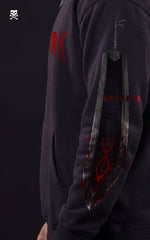 Side view of a Mavrick "Berserk" anime hoodie featuring a detailed graphic of Guts' Dragon Slayer sword on the sleeve, complete with the Brand of Sacrifice symbol and red blood-splatter accents on premium black fabric.