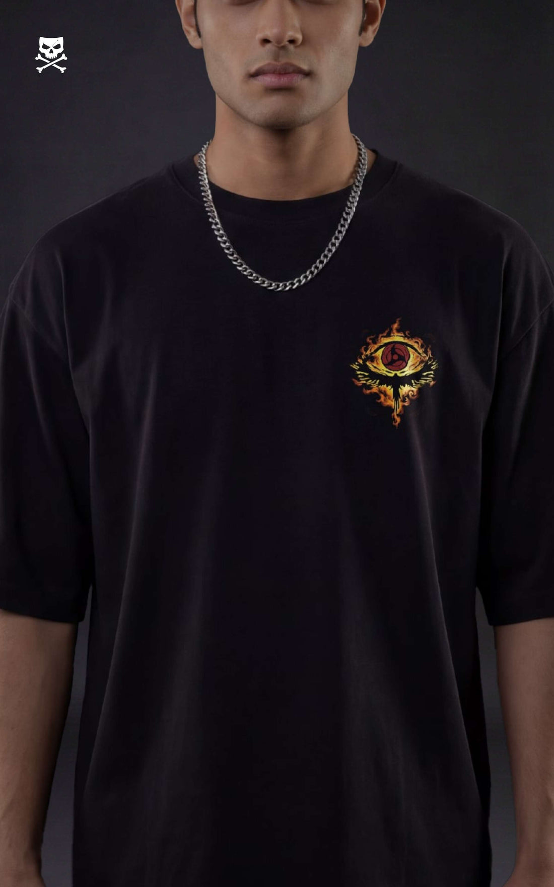 Back view of a model in a black heavyweight oversized t-shirt featuring Itachi Uchiha with a flaming orange Susanoo, black crows, and Japanese kanji streetwear design.