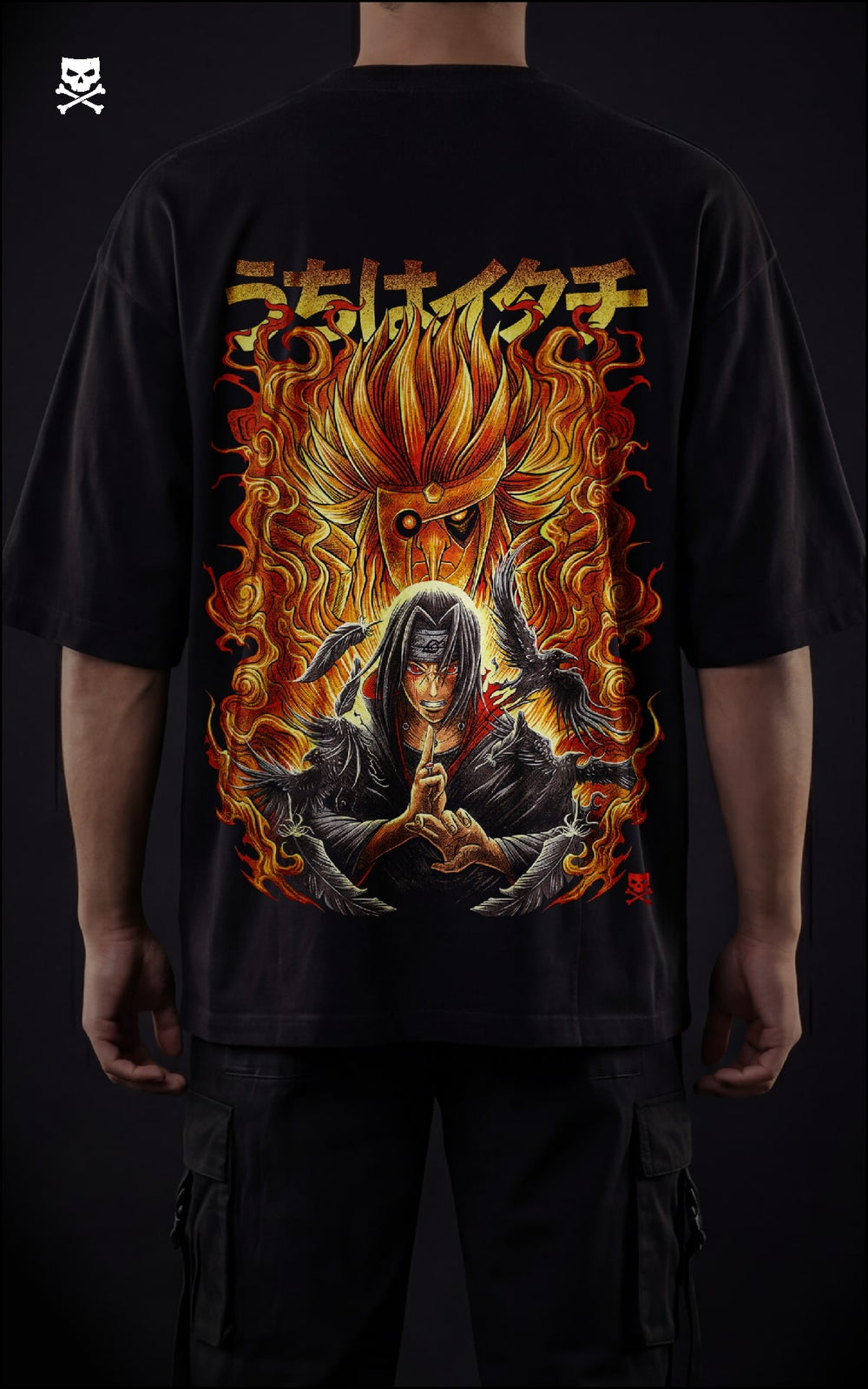 Closeup view of a model in a black heavyweight oversized t-shirt featuring Itachi Uchiha with a flaming orange Susanoo, black crows, and Japanese kanji streetwear design.