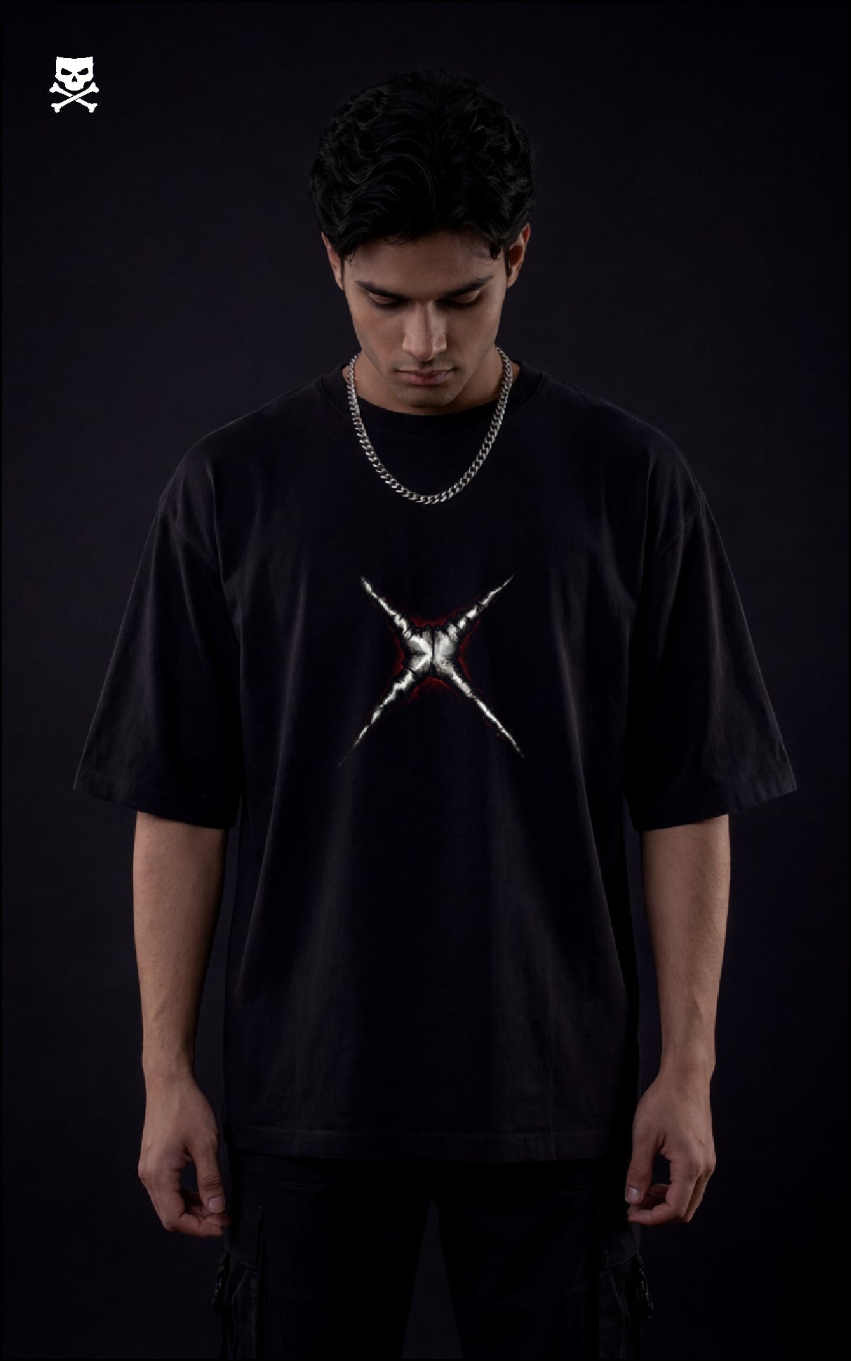 Person wearing a black t-shirt with a white graphic design on a dark background