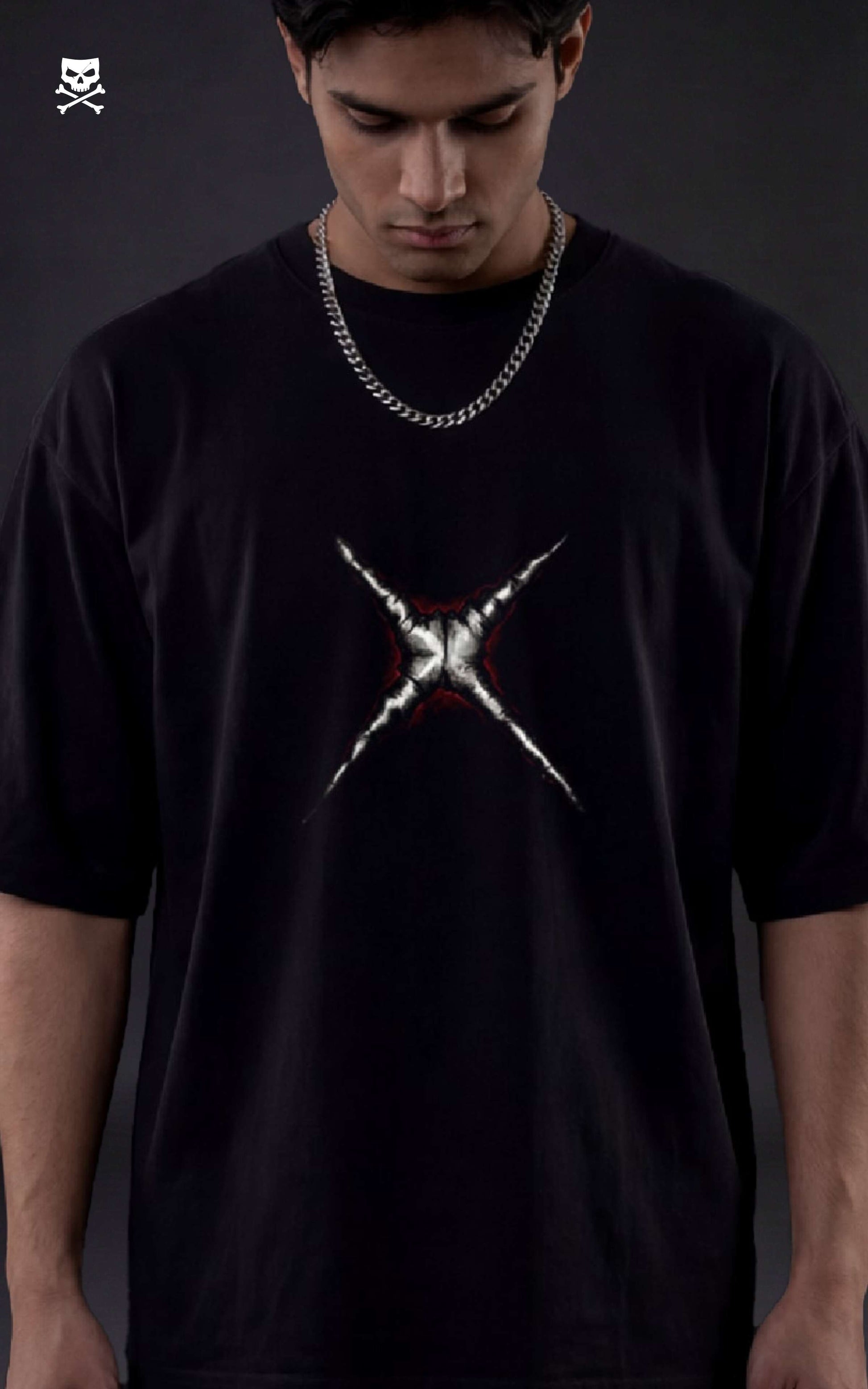 Person wearing a black t-shirt with a white graphic design on a dark background