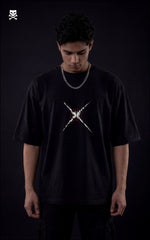 Person wearing a black t-shirt with a white graphic design on a dark background