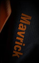 Close-up of the orange raised 3D "Maverick" logo text on the heavy-duty black canvas material of the Saiyan anime travel bag.
