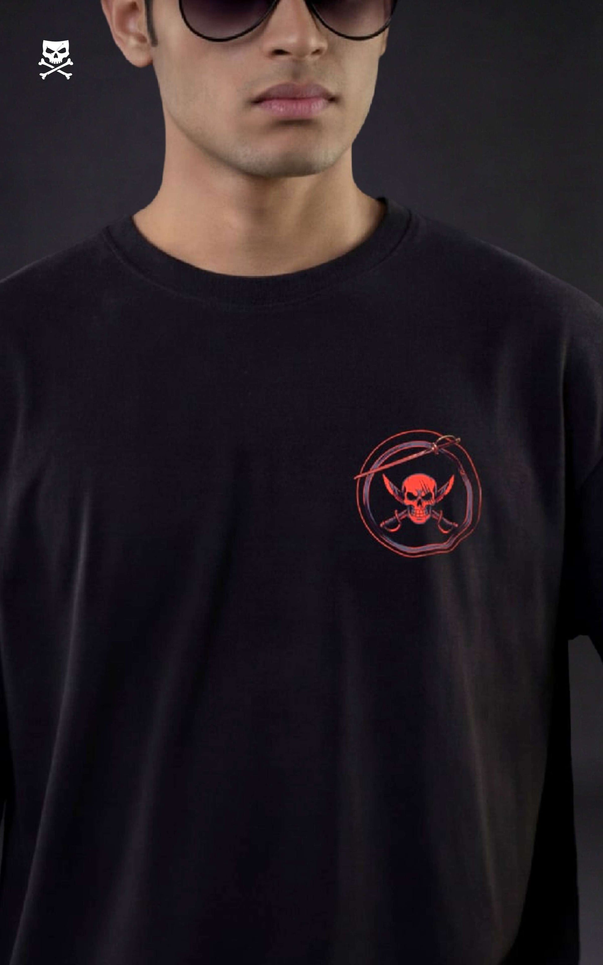Person wearing a black t-shirt with a red logo on a dark background