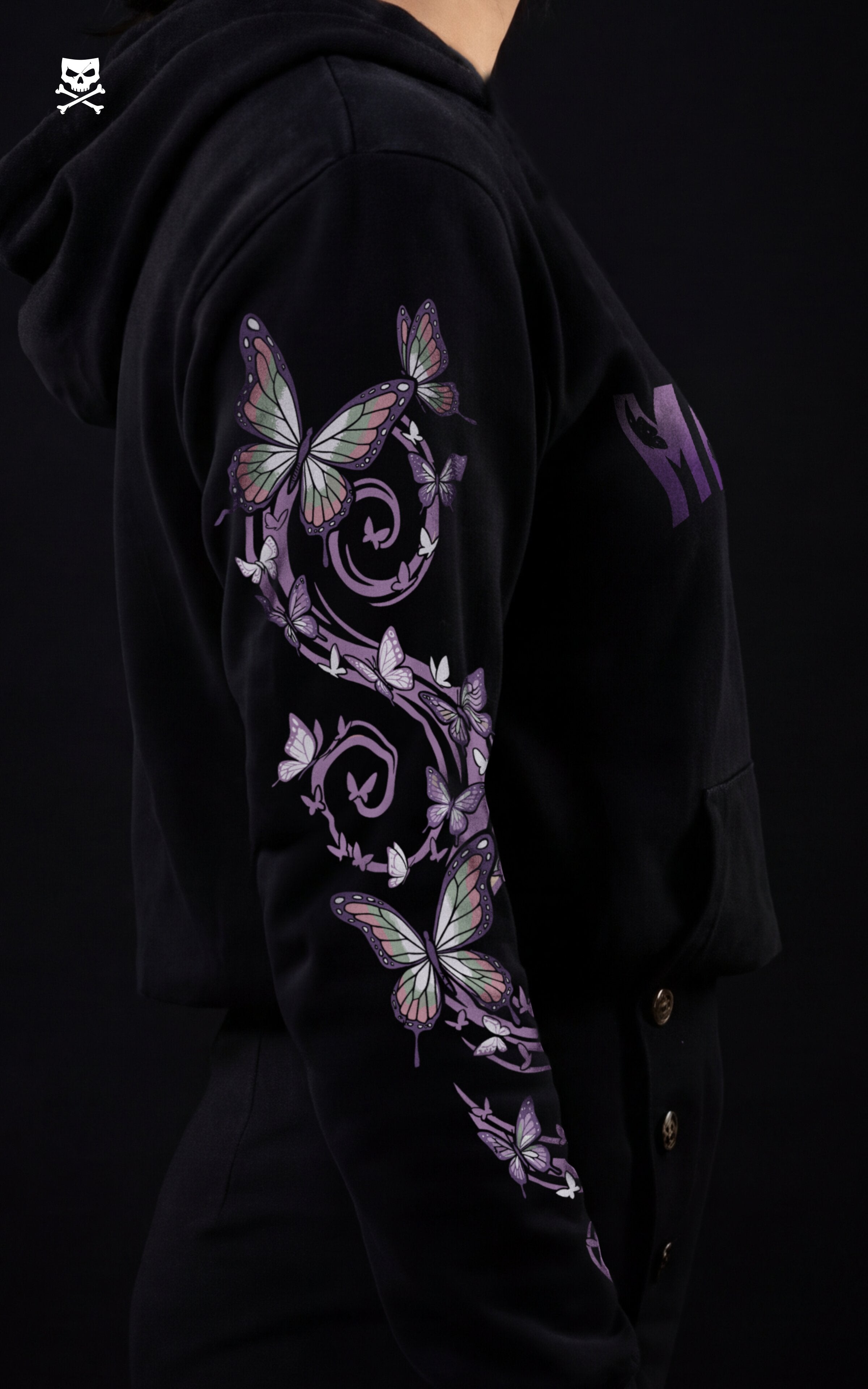 Profile view of a black Demon Slayer streetwear hoodie showing a detailed sleeve print of purple and green butterflies on a vine, inspired by Insect Hashira Shinobu Kocho.