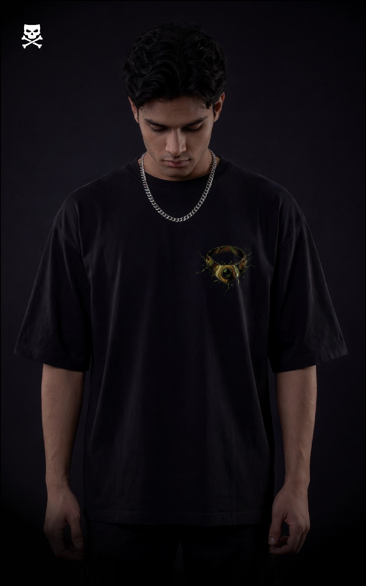 Person wearing a black t-shirt with a yellow broly ring  on a black oversized t-shirt