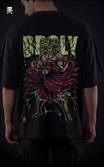 Closeup view of a male model in a drop-shoulder black shirt featuring a Legendary Super Saiyan Broly graphic with neon green energy bursts.