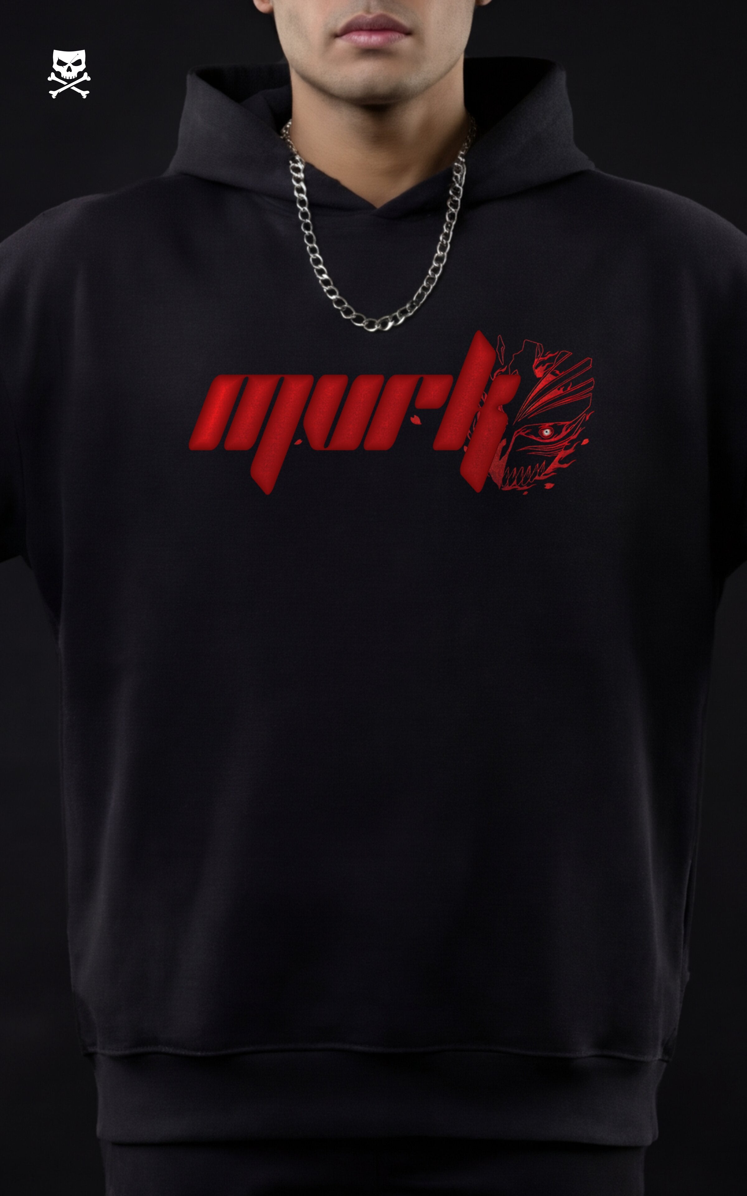 Front-facing portrait of a model in a black MVRK hoodie featuring a red chest logo stylized with half of Ichigo’s Hollow mask, paired with a silver chain.