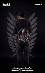 Back view of a female model wearing a boxy black tee with Mikasa Ackerman, her red scarf, and the Scout Regiment Wings of Freedom.