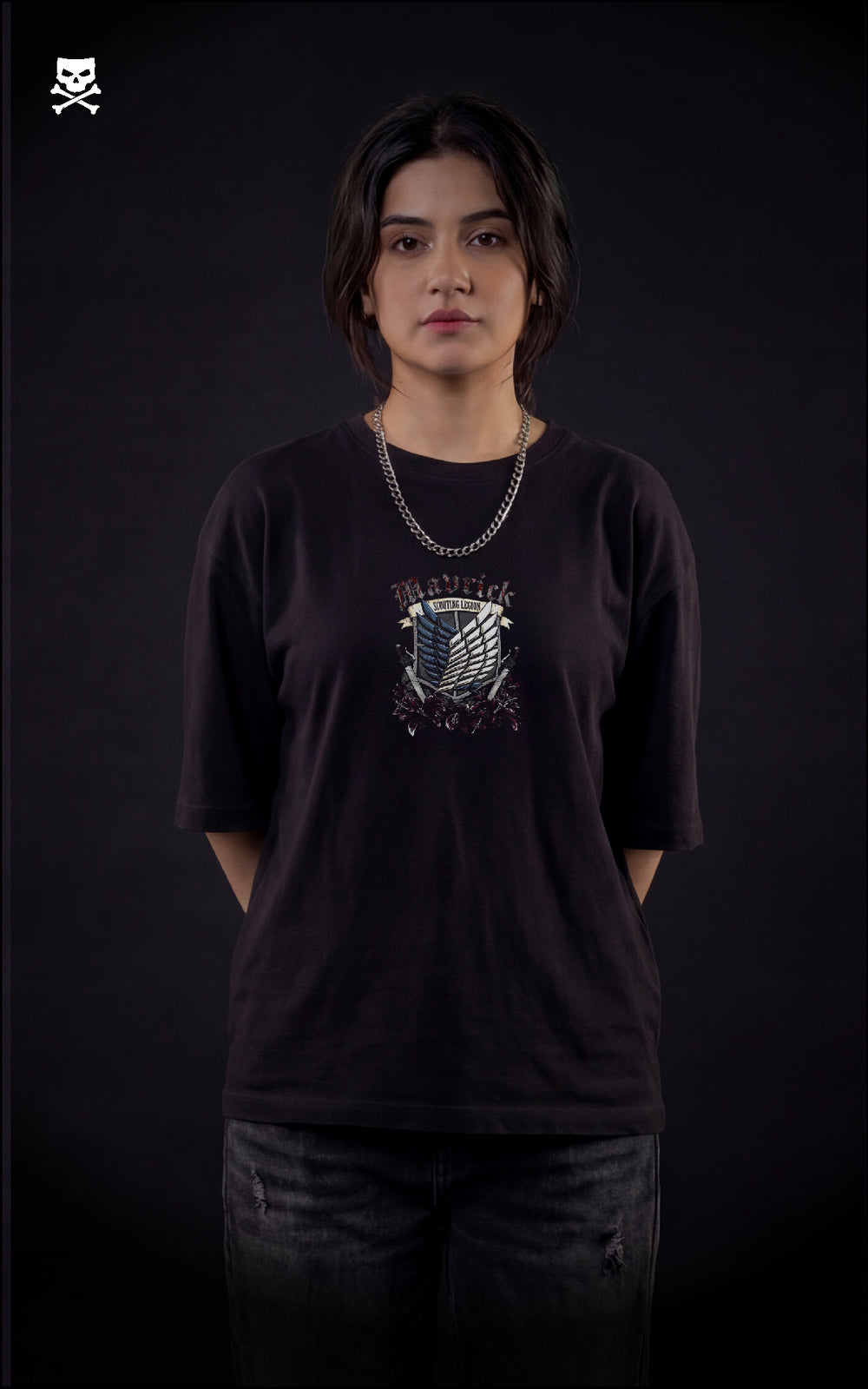 Person wearing a black t-shirt with a graphic design of scout regiment from attack on titan on a dark background