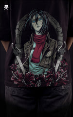 Closeup view of a female model wearing a boxy black tee with Mikasa Ackerman, her red scarf, and the Scout Regiment Wings of Freedom.