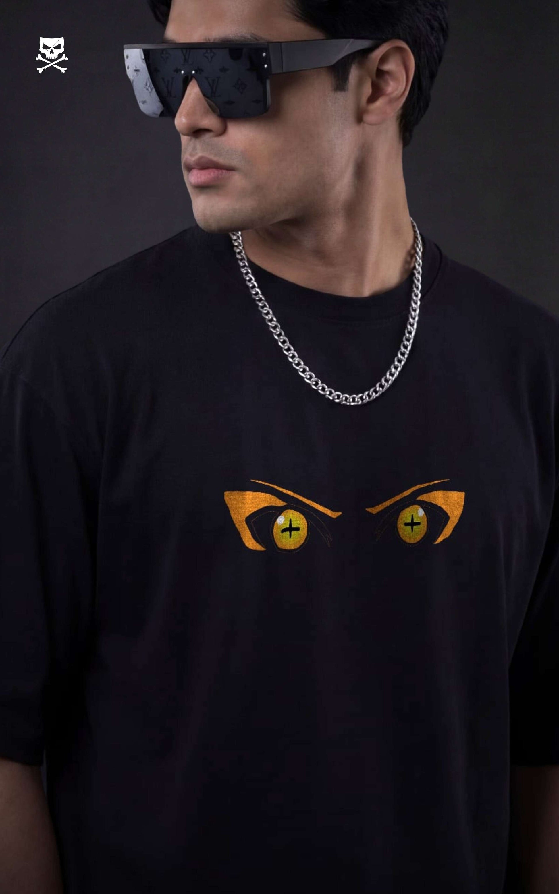 Person wearing a black t-shirt with  naruto sage eyes on front , standing against a dark background